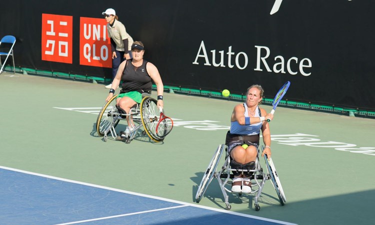 Lucy Shuker lines up a backhand alongside Aniek van Koot at the Japan Open