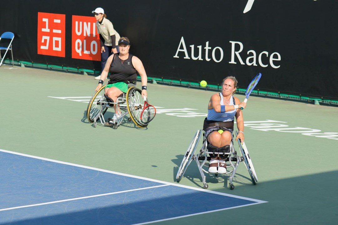 Lucy Shuker lines up a backhand alongside Aniek van Koot at the Japan Open