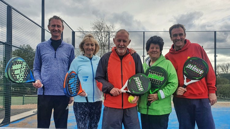 A group of individuals posing with padel rackets to mark the opening of Church Broughton's first ever tennis padel court