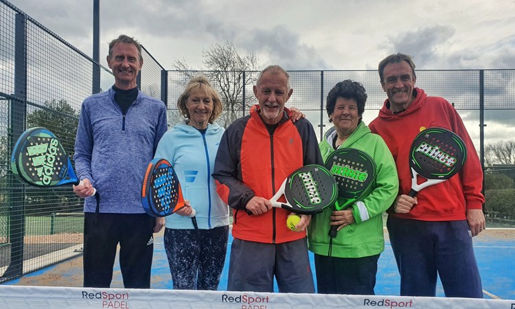 A group of individuals posing with padel rackets to mark the opening of Church Broughton's first ever tennis padel court