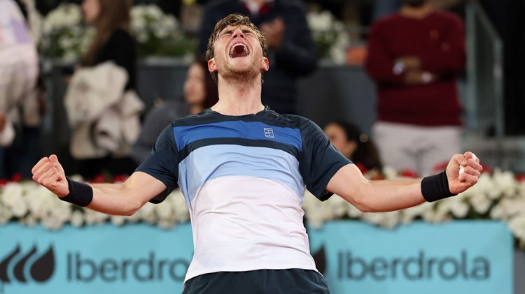 Jack Draper holding out both of his arms while screaming in celebration after reaching the final of the Mutua Madrid Open