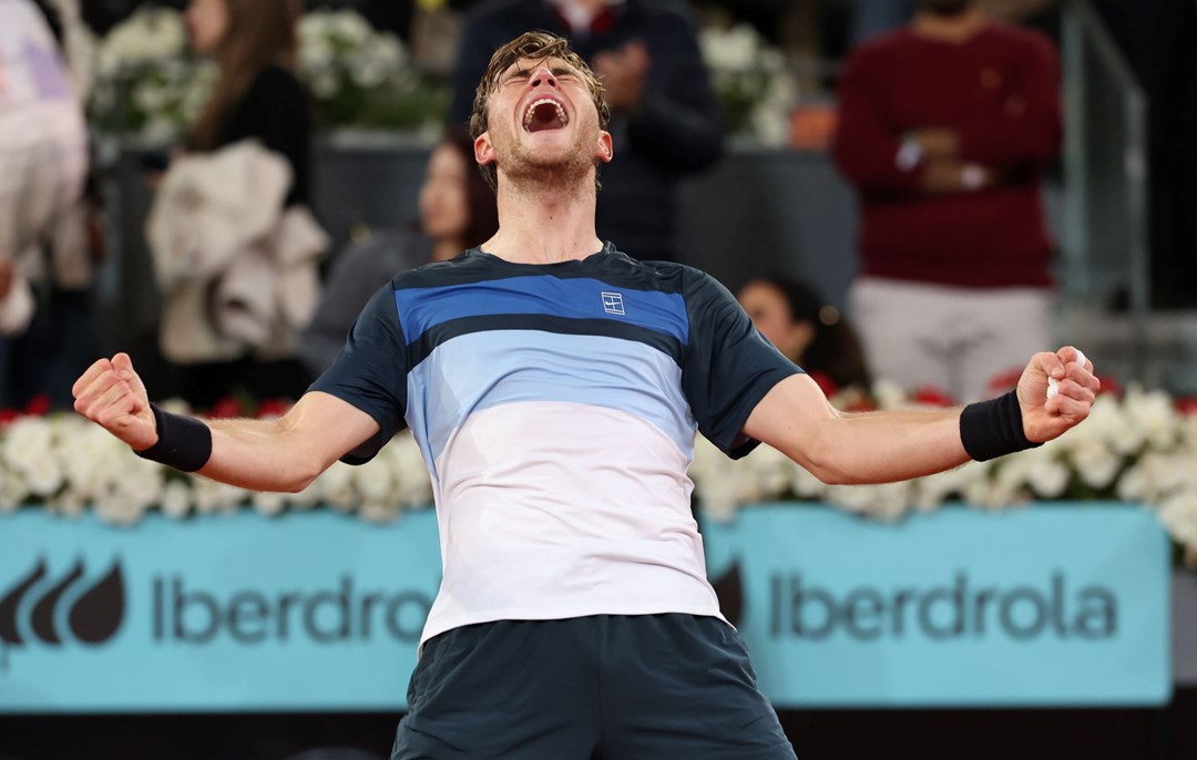 Jack Draper holding out both of his arms while screaming in celebration after reaching the final of the Mutua Madrid Open