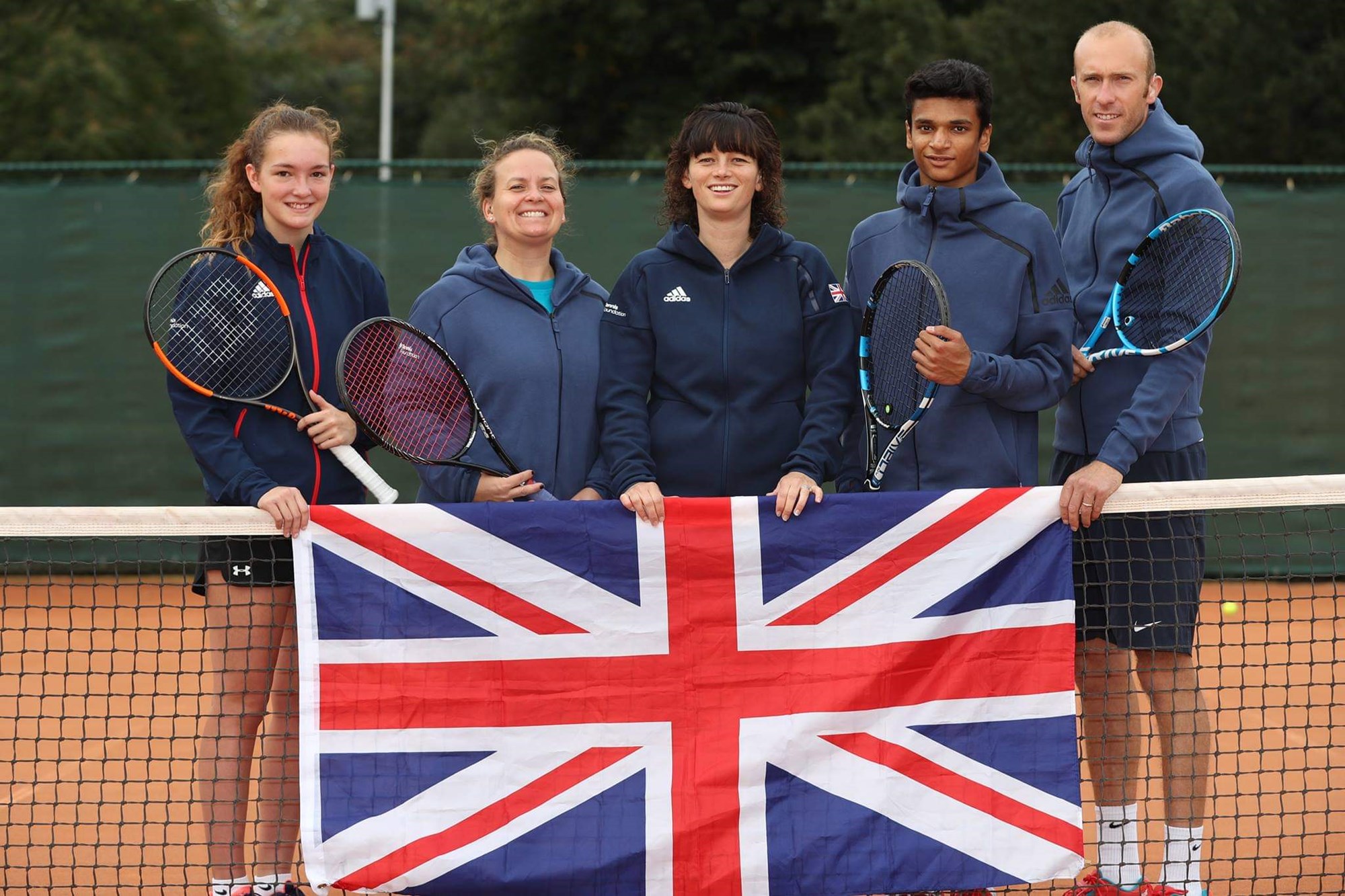 The GB Squad posing for a picture with the GB flag before the World Deaf Tennis Championships