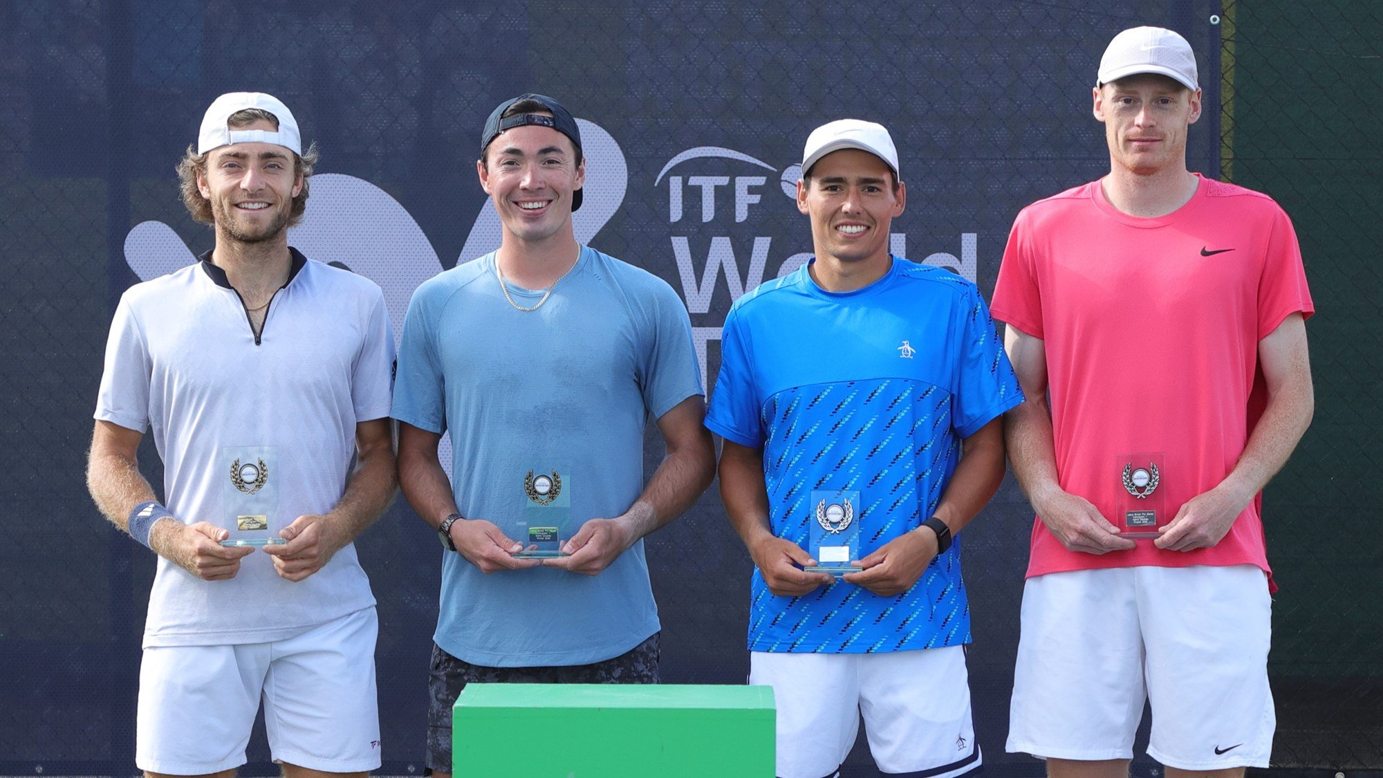 British tennis players Charles Broom and Ben Jones holding their runners-up trophies at the Lexus Pro Series Nottingham event, alongside winners of Justin Boulais and Andres Martin
