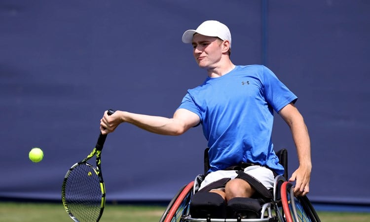 Andrew Penney hits a forehand in the wheelchair exhibition at The Queen's Club in 2024