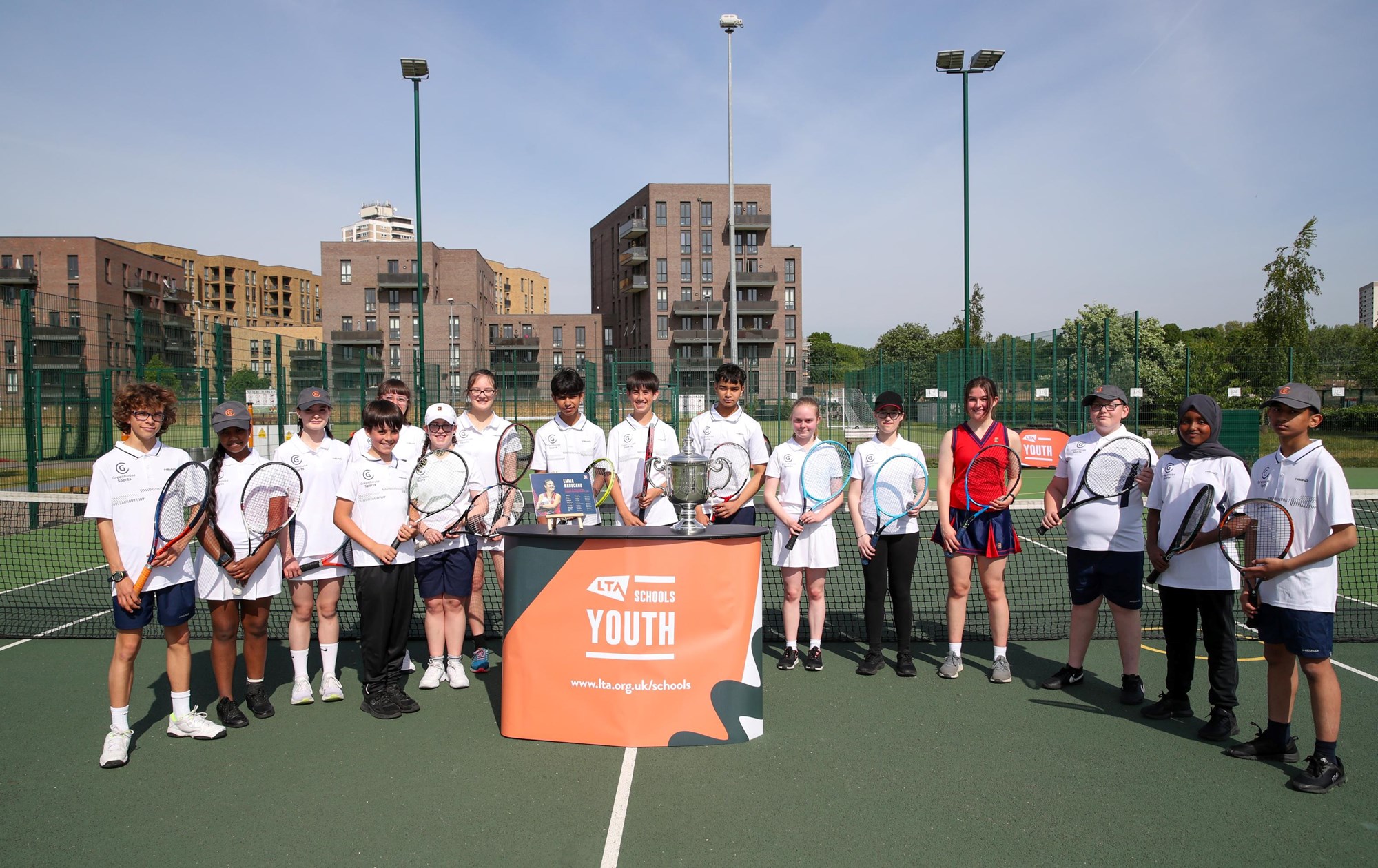 Pupils from St Paul's Way School in Tower Hamlets posing for a picture with Emma Raducanu's US Open Trophy