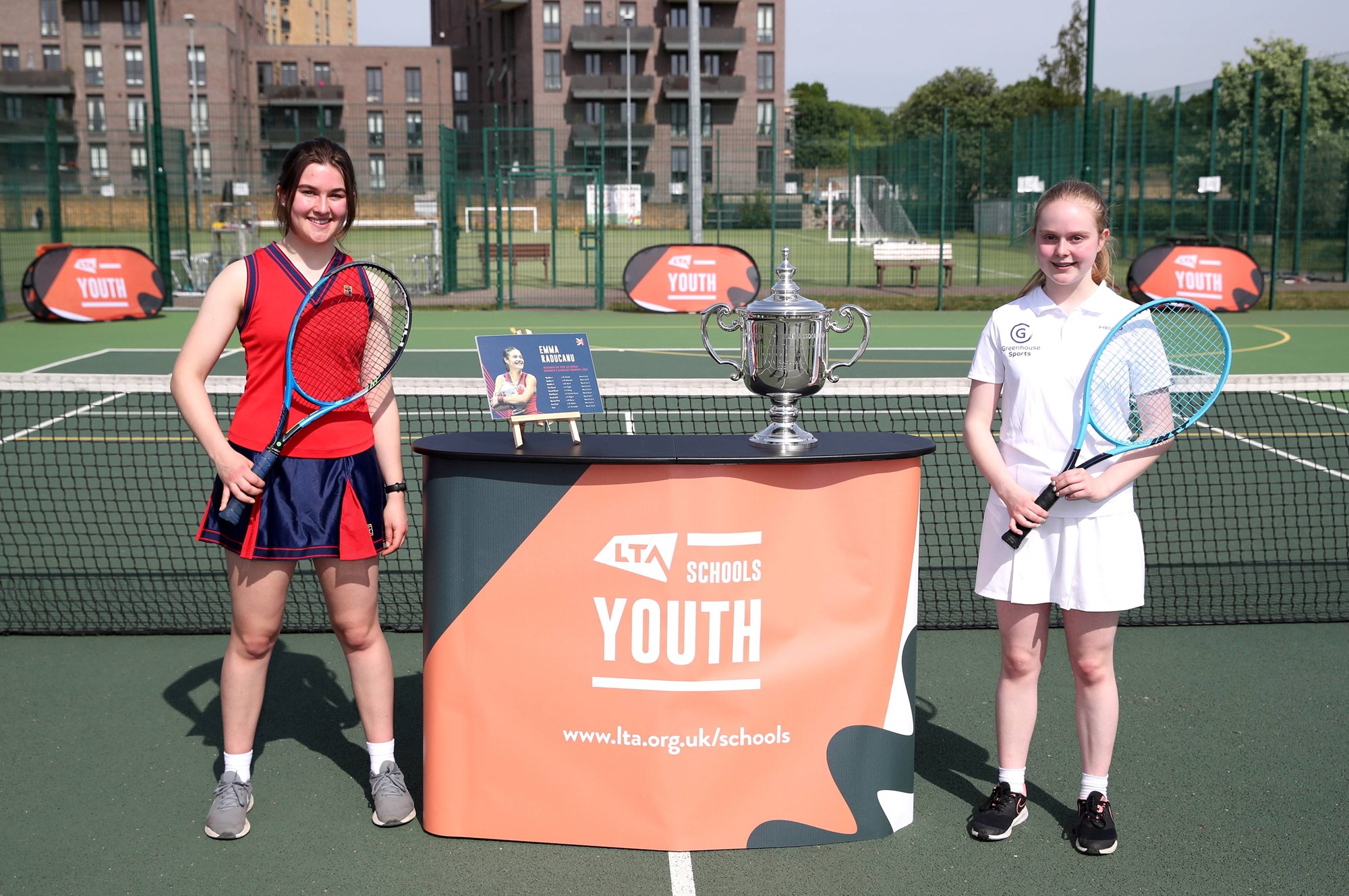 Students from St Paul's School posing with Emma Raducanu's US Open Trophy on day one of the Tour