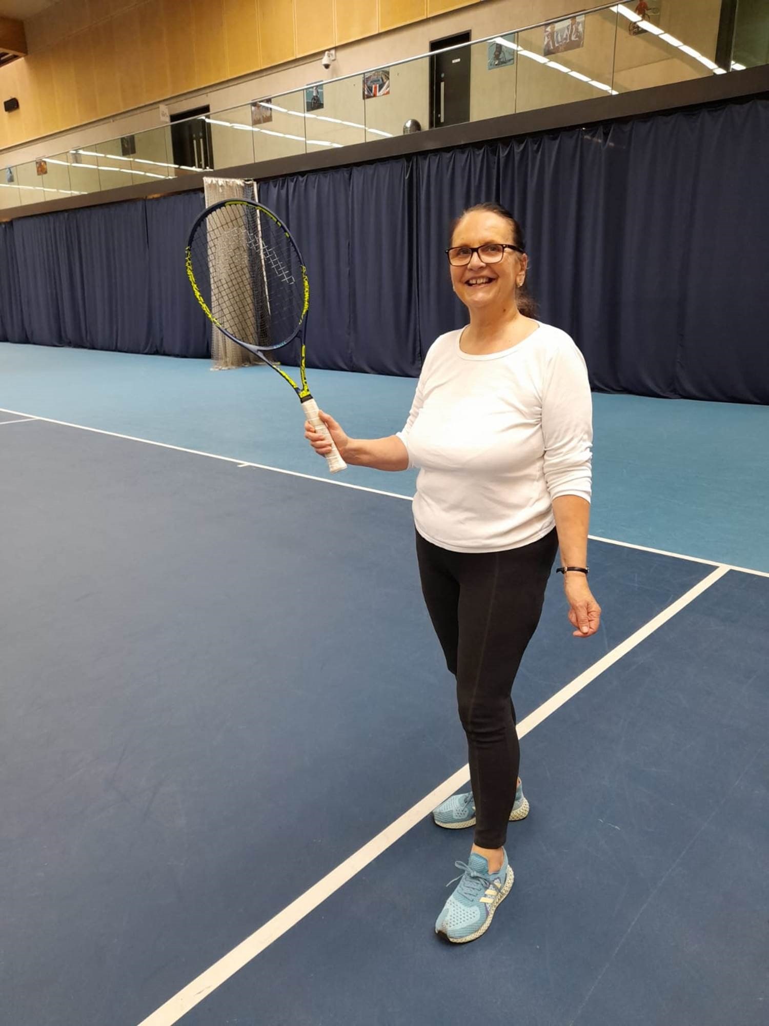 A member of Lee Valley Hockey and Tennis Centre posing for a photo on court during an Open Court session