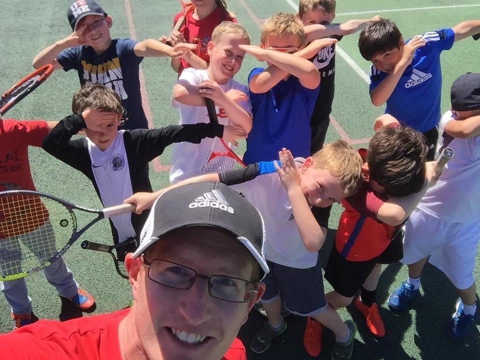 Ian posing for a picture with the kids attending his coaching sessions