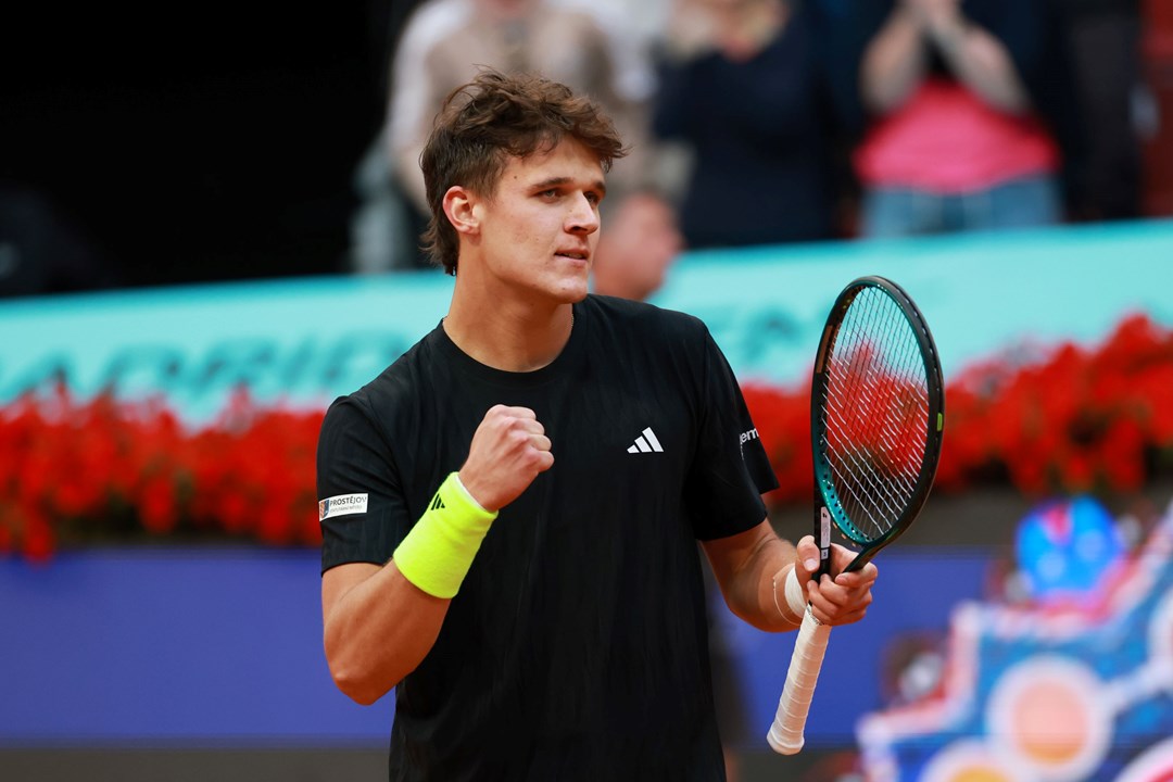 Czech tennis player Jakub Mensik holding his tennis racket and clenching his fist