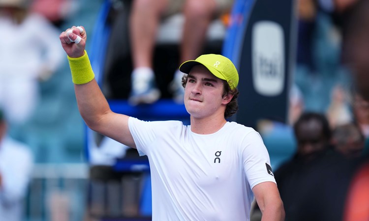 Brazilian tennis star Joao Fonseca holding his fist in the air in celebration