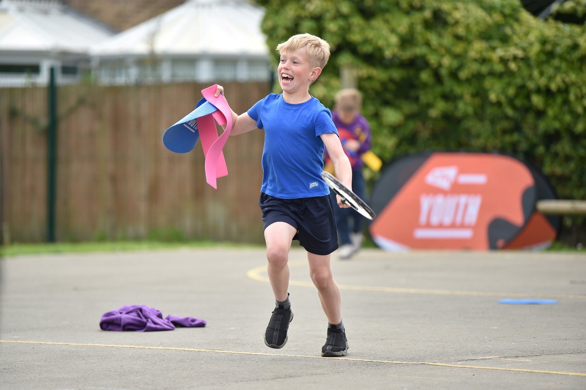 A student from St Bernadette's Primary School, Middlesbrough running during an LTA Youth coaching session