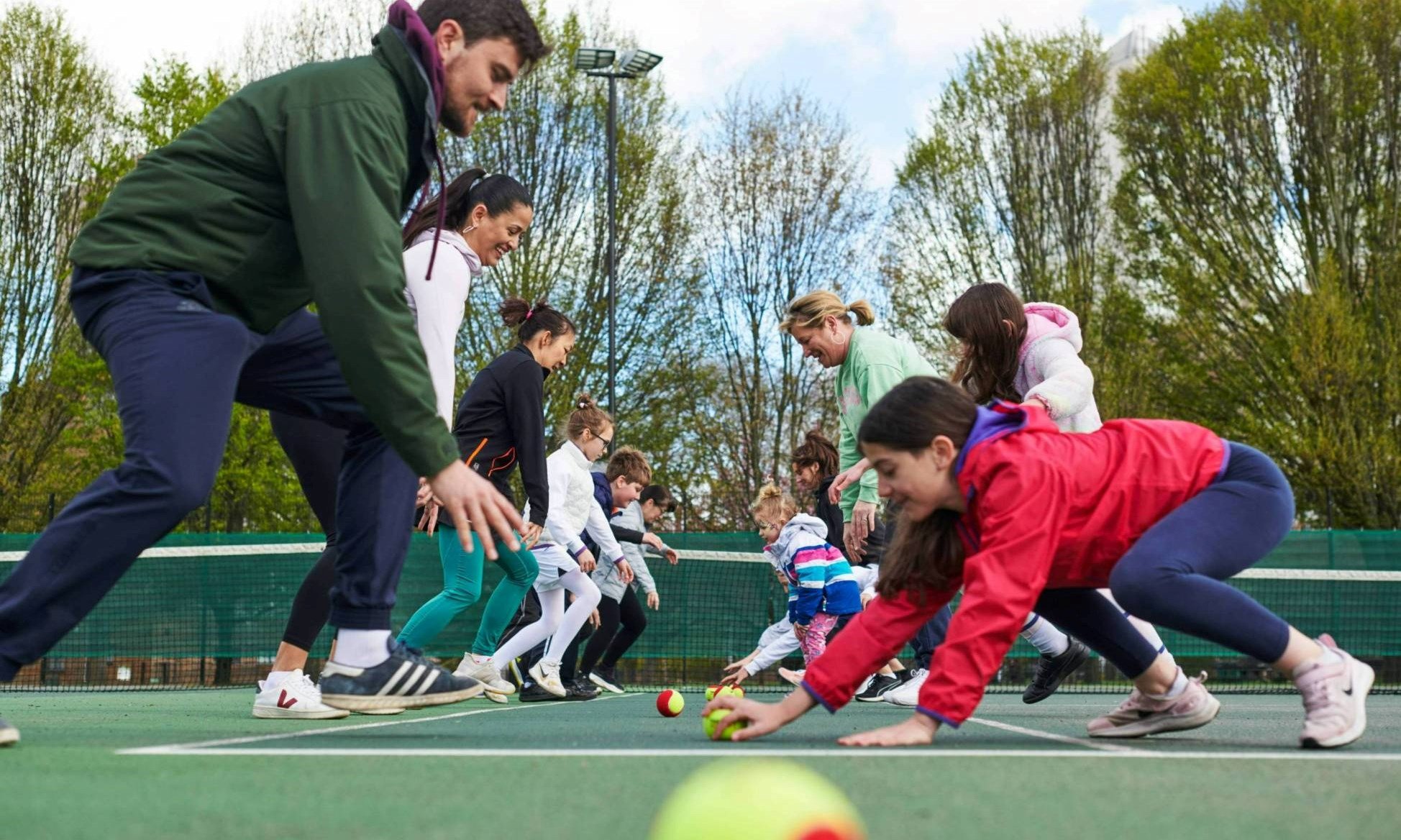 A Free Park Tennis session in action with players enjoying a warm-up drill