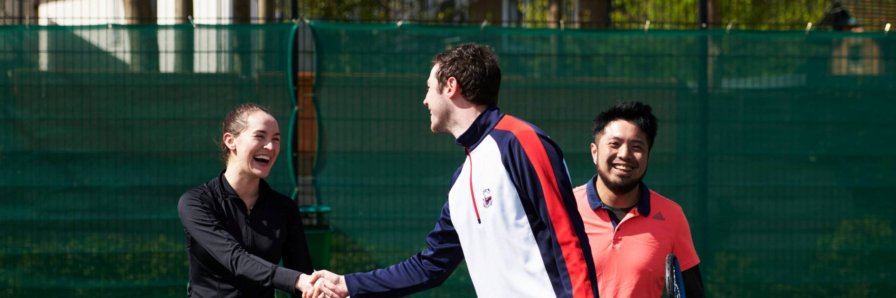 Local Tennis Leagues players shaking hands at the net