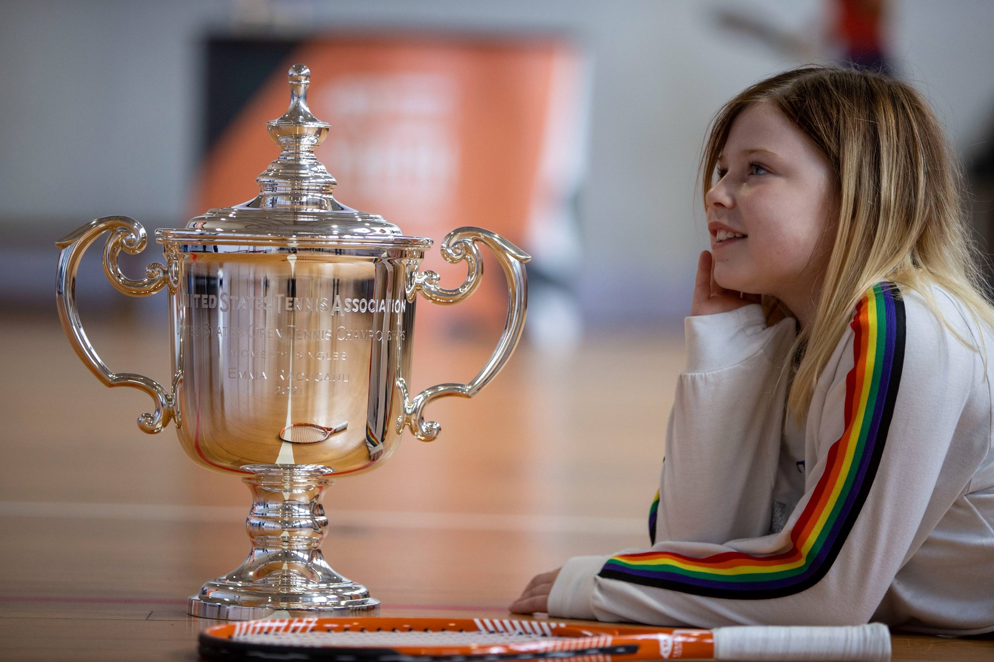 A pupil from Broughton Primary School, Edinburgh posing with Emma Raducanu's US Open Trophy