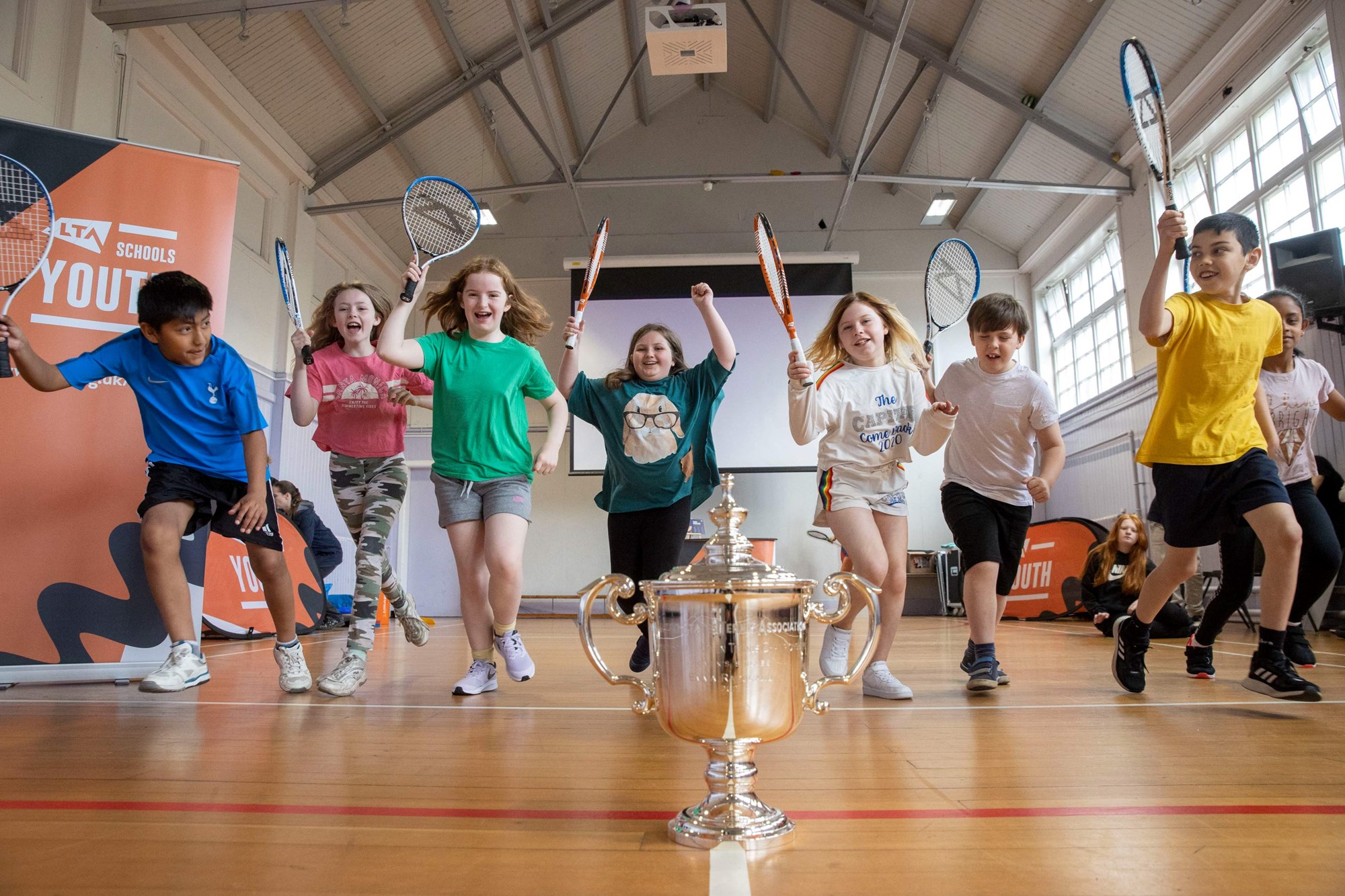 Pupils from Broughton Primary School cheering for the arrival of the US Open Trophy