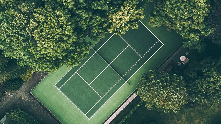 Tennis court situated amongst the trees