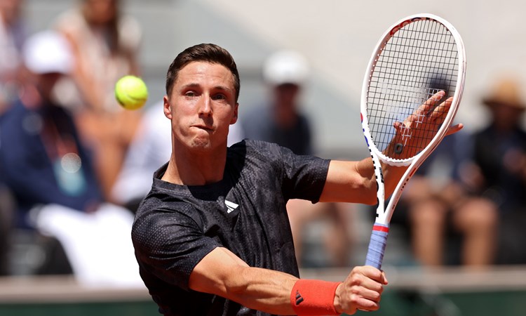 Joe Salisbury plays a backhand during his second round match of the men's doubles at the 2023 Roland Garros.