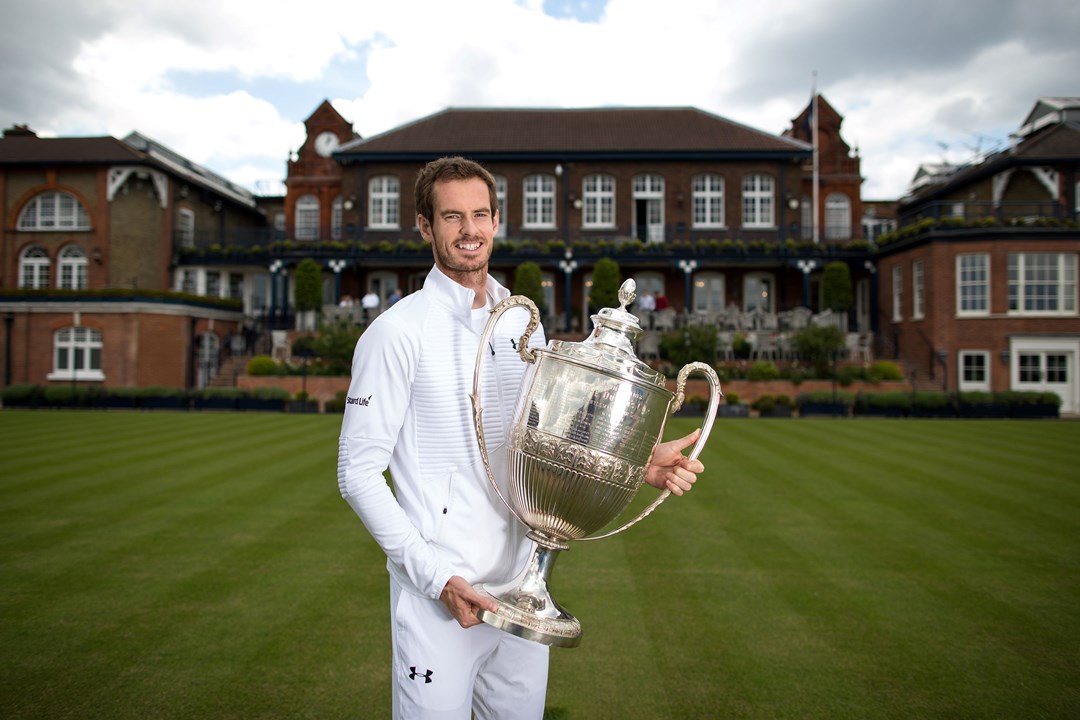 Andy Murray poses with the Queen's Championships trophy at the Queen's Club in 2017