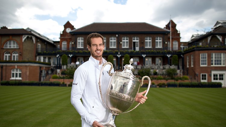 Andy Murray poses with the Queen's Championships trophy at the Queen's Club in 2017