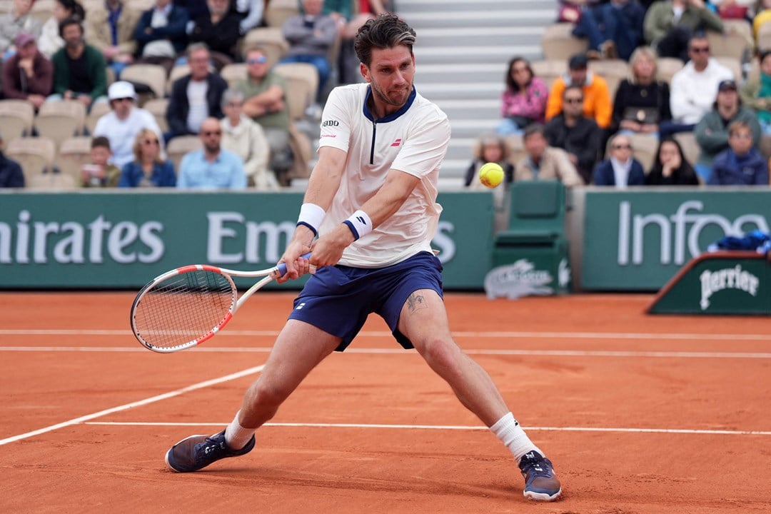 Cam Norrie hits a backhand against Daniil Medvedev in the opening round at Roland Garros
