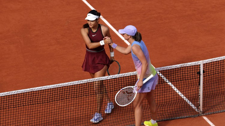Emma Raducanu and Iga Swiatek shake hands during the second round at Roland Garros