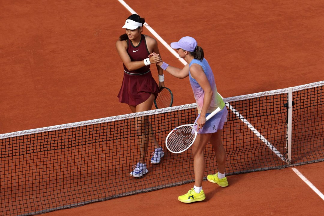Emma Raducanu and Iga Swiatek shake hands during the second round at Roland Garros