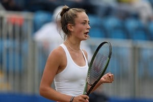 Isabelle Lacy celebrates winning her first round match at the Lexus Surbiton Trophy