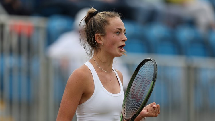 Isabelle Lacy celebrates winning her first round match at the Lexus Surbiton Trophy