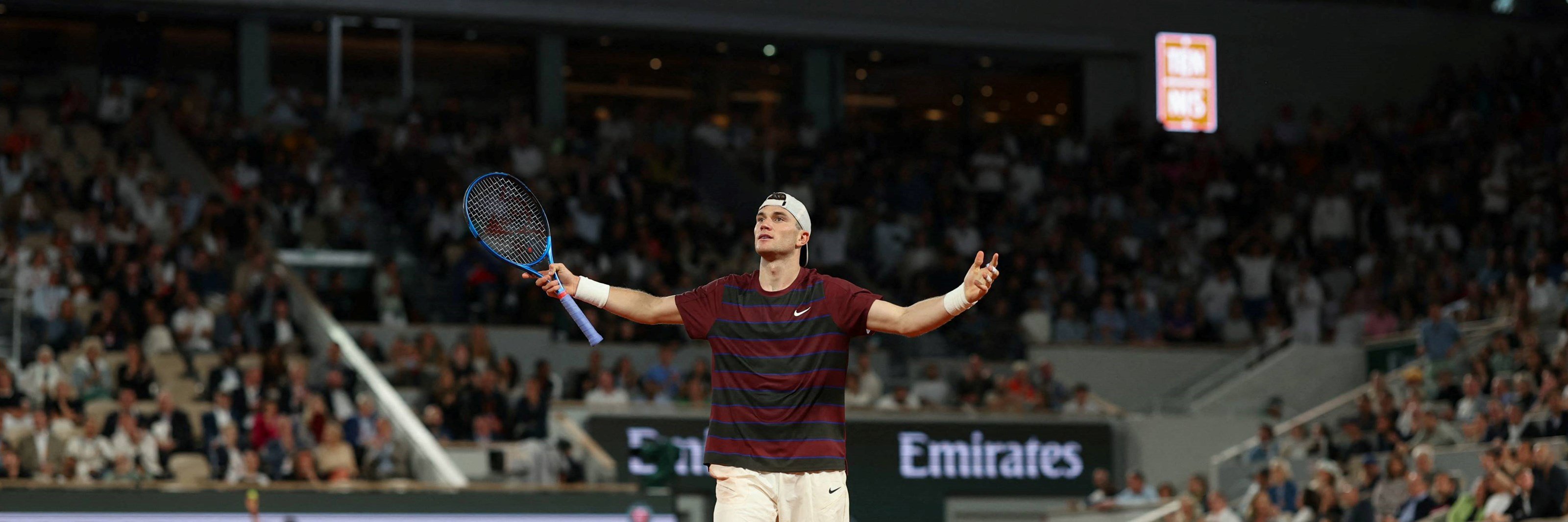 Jack Draper holds his arms out in celebration in the second round at Roland Garros