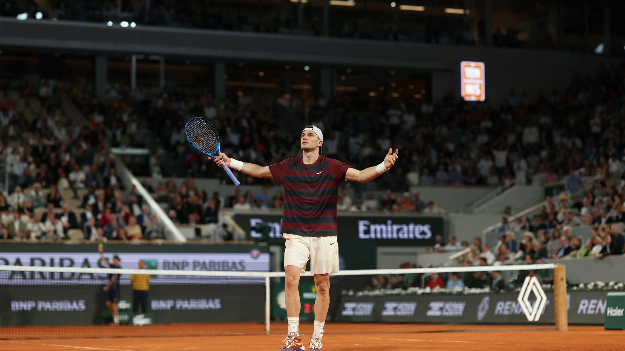 Jack Draper throwing his hands in the air in celebrate during round two win at Roland Garros