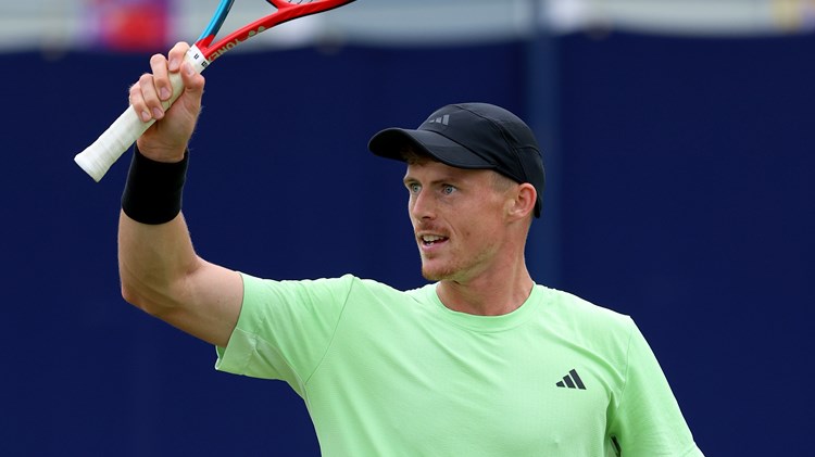 Billy Harris raises a racket in celebration at the Lexus Surbiton Trophy