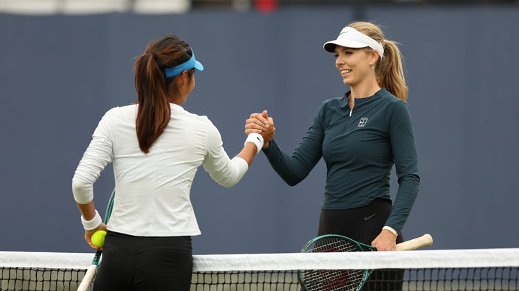 Katie Boulter and Emma Raducanu high five during practice at the HSBC Championships