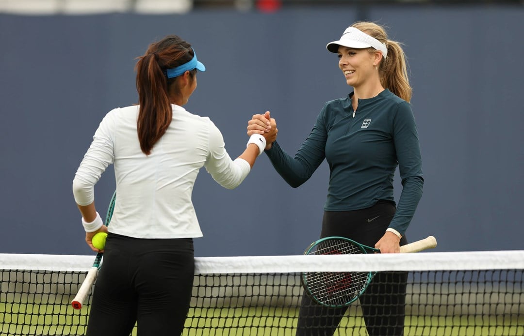 Katie Boulter and Emma Raducanu high five during practice at the HSBC Championships