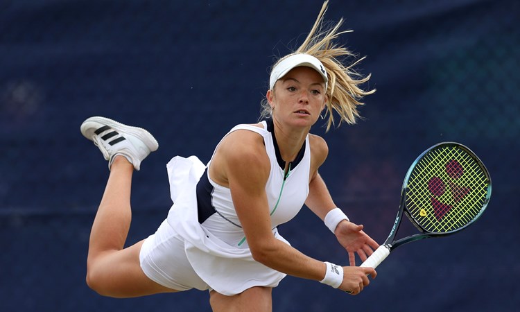 Katie Swan hitting a serve on court at the Lexus Surbiton Trophy