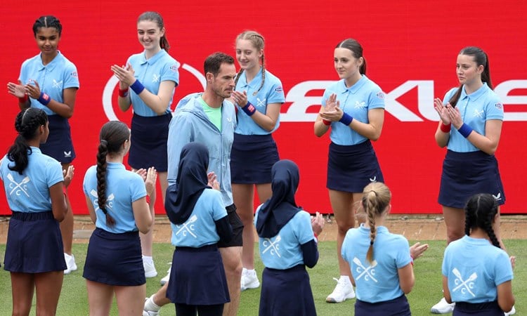 Andy Murray being surrounded and clapped by the ball kids as he walks onto the Andy Murray Arena at the HSBC Championships