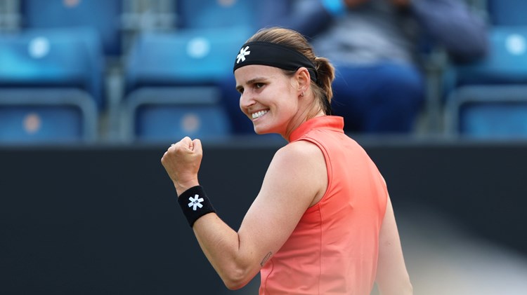 Greet Minnen celebrates winning a point during the final of the Lexus Birmingham Open