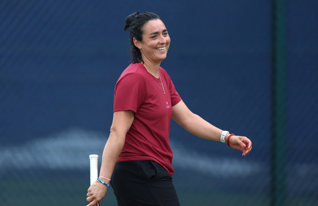 Ons Jabeur smiles whilst training with Emma Raducanu