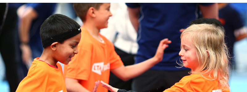 Kids playing tennis at an LTA SERVES event