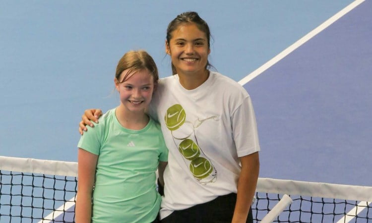 Emma Raducanu stood next to 11-year-old Joanie at the net at the National Tennis Centre