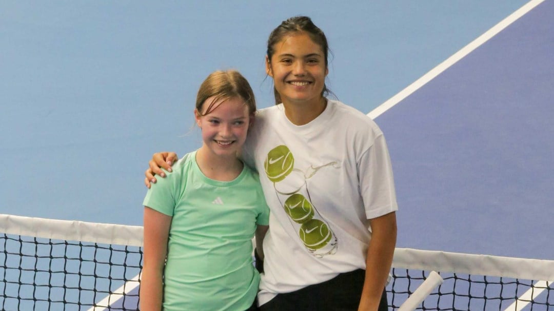 Emma Raducanu stood next to 11-year-old Joanie at the net at the National Tennis Centre