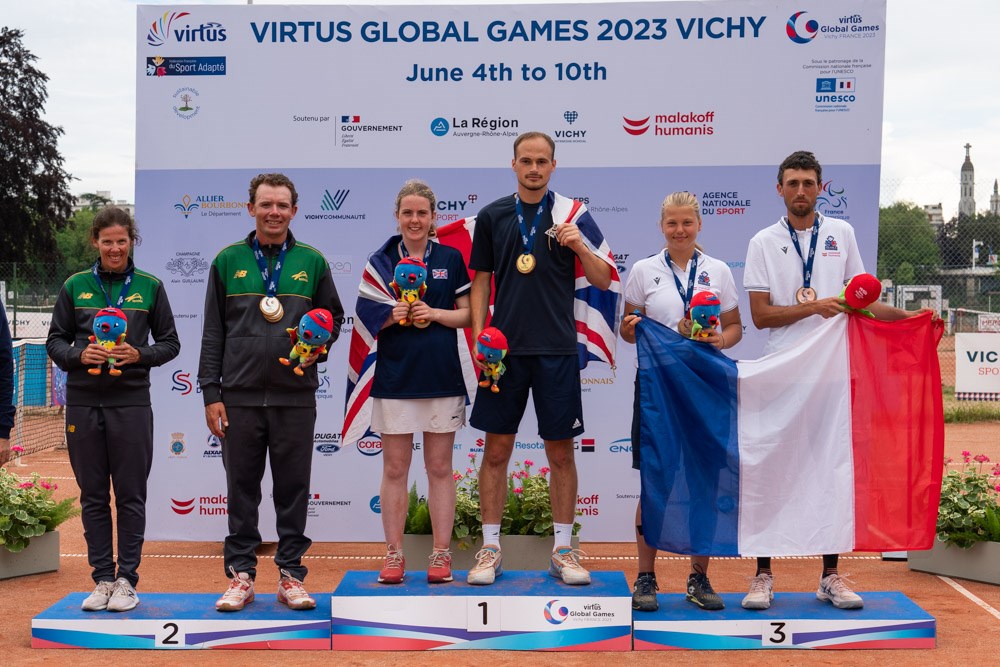 Great Britain's Anna McBride and Dominic Iannotti stood side by side on the winner's podium alongside silver medallists and bronze medallists France after winning gold in the Mixed Doubles II1 event at the 2023 Virtus Games held in Vichy, France.