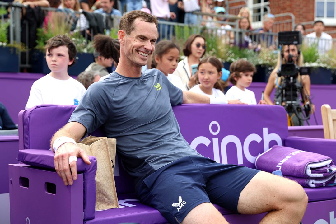 Andy Murray sitting in a cinch branded chair on court at the cinch Championships while smiling
