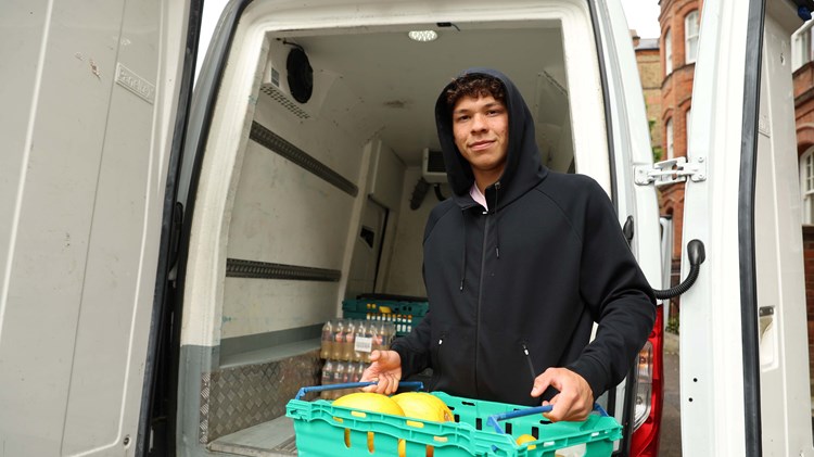 Ben Shelton carrying a food box that has been unloaded out of a van at the cinch Championships