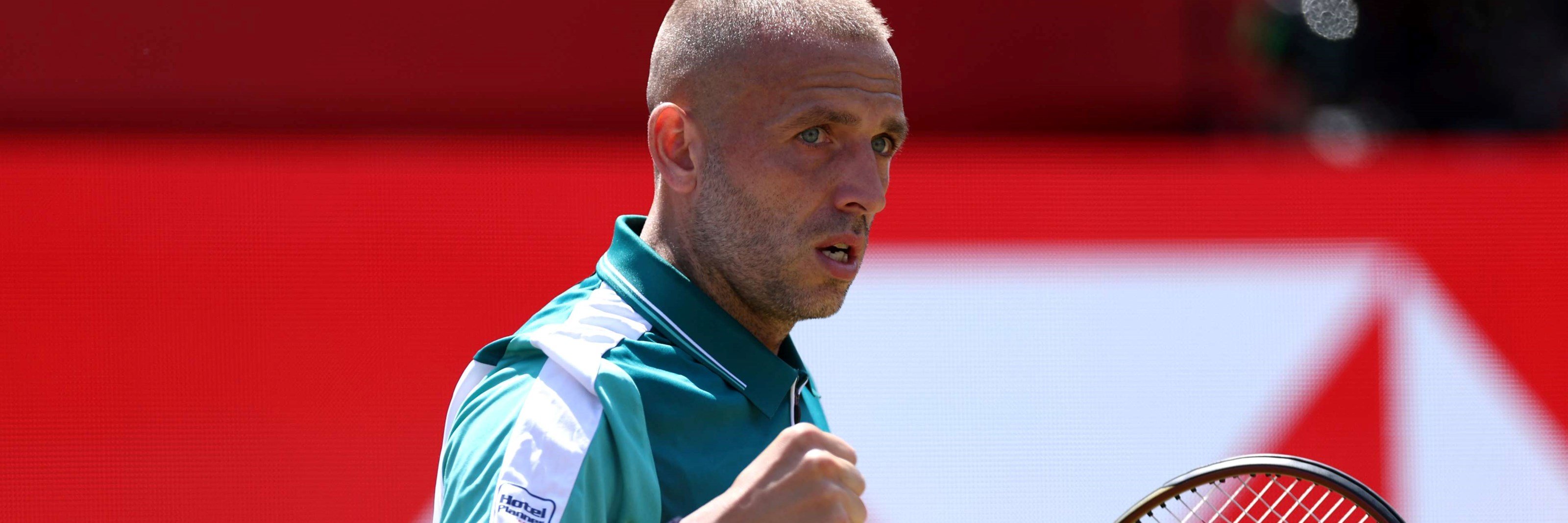 Dan Evans celebrates winning a point against Frances Tiafoe at the HSBC Championships