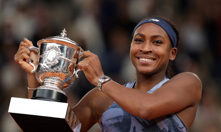 Coco Gauff holding up the Roland Garros trophy after winning the 2025 final