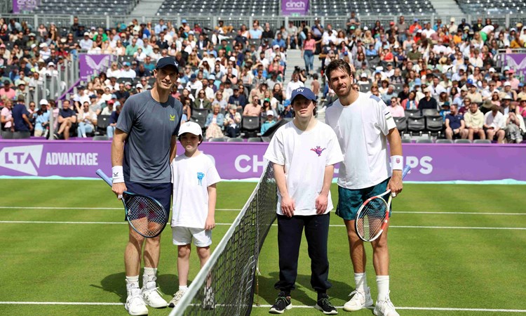 Andy Murray and Cam Norrie stood either side of a tennis net next to two children on court at the cinch Championships