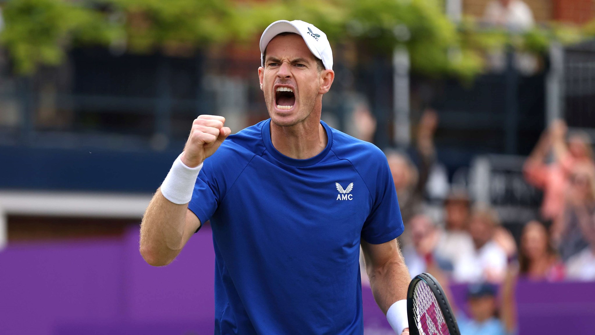 Andy Murray wearing a blue AMC kit while clenching his fist and cheering at the cinch Championships