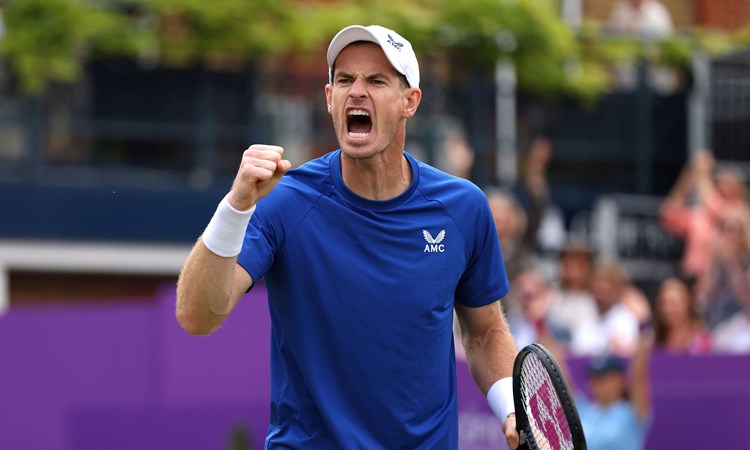 Andy Murray wearing a blue AMC kit while clenching his fist and cheering at the cinch Championships