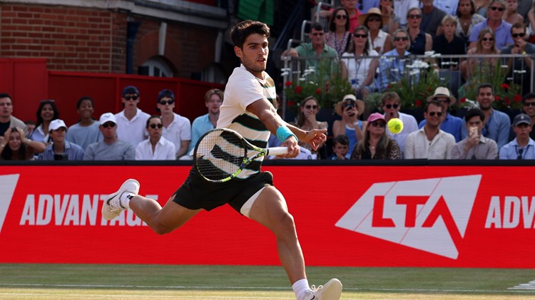 Carlos Alcaraz leaps to reach a volley on the grass court at the HSBC Championships